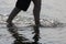 Light sparkling off water as lady paddles in sea