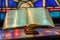 Light from stained glass window falls on open bible in american church