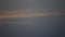 Light strip of aircraft in darkening sky