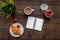 Light summer lunch. Coffee, strawberry, croissant on wooden background top view