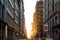 The light of summer sunset shines between the buildings on 19th Street in New York City