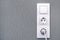 Light switch , power sockets, lead and plug on gray wall