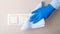 Light switch surfaces disinfection. Woman in rubber blue glove clean light switch with cloth on wall by wet rag. New normal Covid