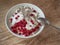 Light and tasty Breakfast with homemade cottage cheese, seeds and berry jam on a rough wooden background at close range