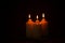 Light, Three Illuminated Candles on a black background copy-space, Celebration