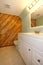 Light tones bathroom with a wooden panel wall