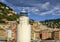 Light tower with seagull on top on a jetty with Camoglia in the background, Italy