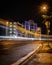 Light trails of cars moving past a modern apartment block