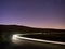 Light trails on rural road, cat and fiddle