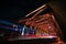 Light trails of traffic on red steel bridge at night