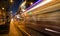 Light trails of a tram driving a street by night