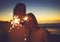 Light up the night with some magic. a young couple playing with sparklers on the beach at night.