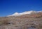 Light winter snow on eroded mountains