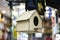 Light wood color bird house. It hangs in the air. Photographed in front of the store and for sale. Close up