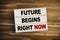 Lightbox or light box with message Future begins right now on wooden table background