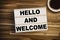 Lightbox or light box with message Hello and welcome on a wooden table