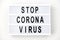 Lightbox with stop coronavirus caution words