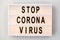 Lightbox with stop coronavirus caution words