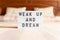 Lightbox with text: wake up and dream, on the bed