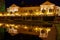 Lighted Baroque building with water reflection summer night scene in German spa town