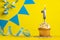Lighted birthday candle number 1 - Yellow background with blue pennants
