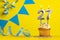 Lighted birthday candle number 27 - Yellow background with blue pennants