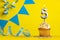 Lighted birthday candle number 5 - Yellow background with blue pennants