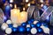 Lighted candles and blue white Christmas tree decorations on the