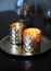 Lighted candles in golden candlesticks on a round gold tray