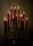 Lighted candles on iron candlestick