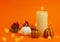 Lighted decorative pumpkin candles on an orange background with boke