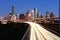 Lighted Houston skyline against blue sky