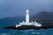 Lighted Lismore lighthouse in Scotland at dusk