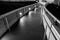 Lighted pathway at night with brick walls and handrail