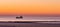 Lighted ship sailing in the sea at sunset, the Belgian coast, nature and transport background