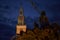 Lighted spire of the St. Marienchurch behind the Neptune`s Fountain in Berlin at night.