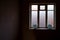 a lighted window in the black room of an abandoned house, a clear outline, glass covered with frost,