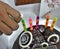 Lighten the colourful cerebration candles on Chocolate cake and biscuit on white background