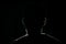 Lighten portrait silhouette of a human head in the dark background