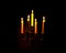 Lightened candles on dark background