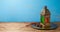 Lightened lantern and dates fruit on wooden table over blue background