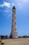 The lighthouse of Arikok Natural Park on the island of Aruba in the Caribbean Sea with deserts and ocean waves on the rocky coast