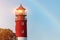 Lighthouse in Baltiysk port. Beautiful rainbow and beacon lights. Clean blue sky