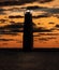 Lighthouse beam shines in a vibrant sunset