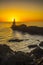 Lighthouse during a beautiful orange sunset in the Pasajes San Juan, Gipuzkoa, Spain