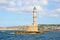 Lighthouse. Beautiful view to the rocky coast with ancient architecture. Seaport touristic town Chania, Creete island, Greece.