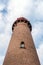 Lighthouse bottom-up view against a beautiful sky. Brick wall lighthouse