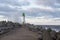 Lighthouse and breakwater in Baltic sea near the port