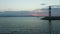 Lighthouse and breakwater with fishing boat moving