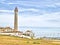 Lighthouse with bright blue sky background.